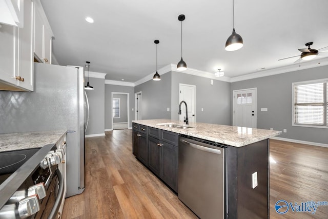 kitchen featuring appliances with stainless steel finishes, ceiling fan, sink, white cabinetry, and hanging light fixtures