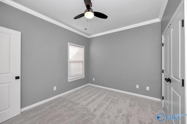 unfurnished bedroom featuring ceiling fan, light carpet, and ornamental molding