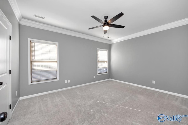 carpeted empty room with a wealth of natural light, crown molding, and ceiling fan