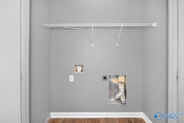 clothes washing area featuring electric dryer hookup, hookup for a washing machine, and hardwood / wood-style floors