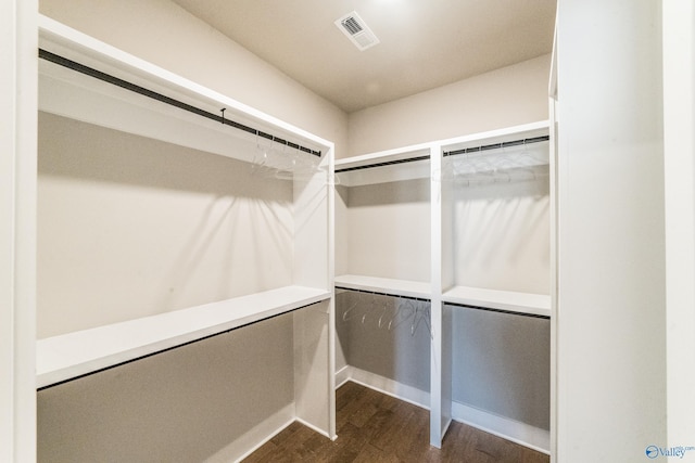 walk in closet with hardwood / wood-style flooring