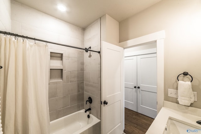 bathroom featuring wood-type flooring, vanity, and shower / tub combo with curtain