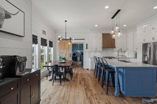 254 Whitlow Rd, Decatur, AL 35603 - kitchen featuring stainless steel appliances, a chandelier, white cabinetry, ornamental molding, and light stone counters