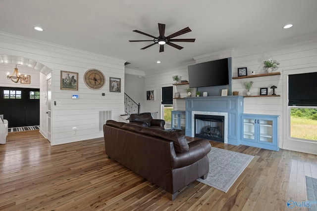 254 Whitlow Rd, Decatur, AL 35603 - living room with wooden walls, stairway, a chandelier, wood-type flooring, and ceiling fan