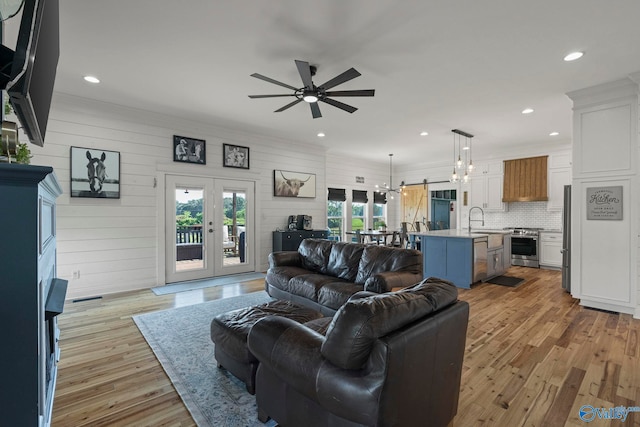 254 Whitlow Rd, Decatur, AL 35603 - living area featuring a ceiling fan, light wood-style flooring, recessed lighting, a chandelier, and french doors