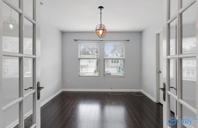 empty room with french doors and dark hardwood / wood-style floors