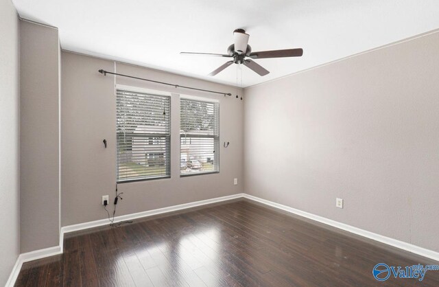 unfurnished room with ceiling fan and dark hardwood / wood-style floors