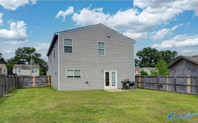 back of house featuring a yard