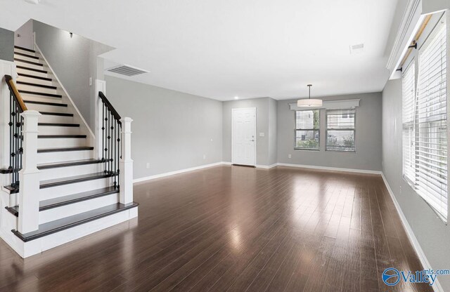 unfurnished living room featuring dark hardwood / wood-style flooring