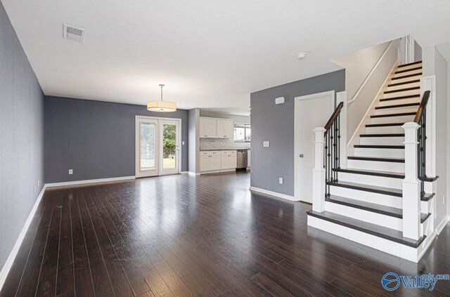 unfurnished living room with dark hardwood / wood-style floors