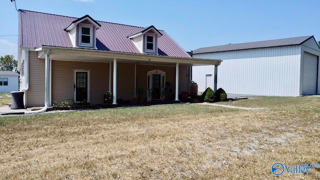 view of front of home featuring a garage, a front lawn, and covered porch