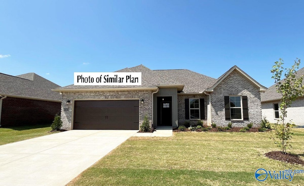 255 John Harold Dr, Meridianville, AL 35759 - view of front facade featuring a garage, a front yard, brick siding, driveway, and roof with shingles