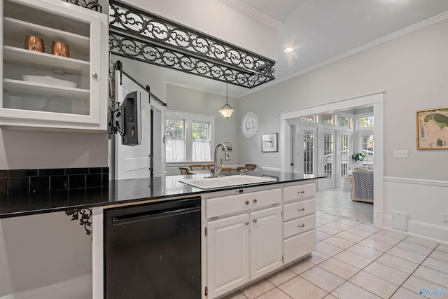 kitchen with white cabinets, ornamental molding, sink, light tile patterned floors, and dishwasher