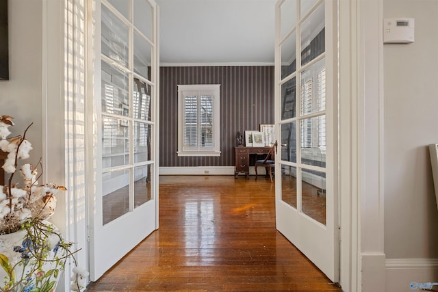 interior space with french doors, hardwood / wood-style flooring, and ornamental molding