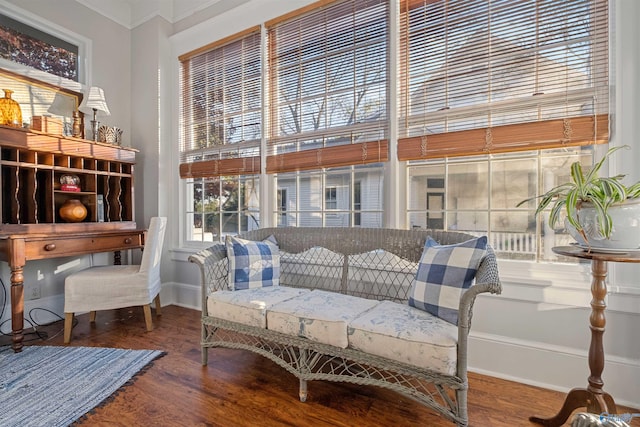 sitting room with hardwood / wood-style flooring and ornamental molding