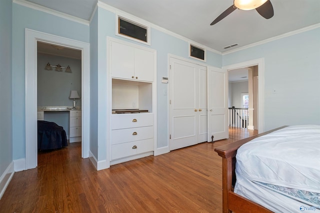 bedroom featuring hardwood / wood-style flooring, ceiling fan, and ornamental molding