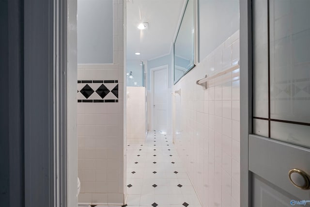 bathroom featuring a shower and tile walls