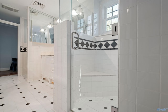 bathroom featuring tile walls and walk in shower