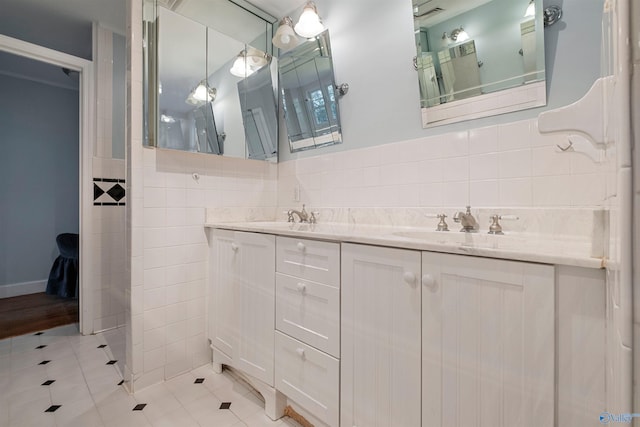 bathroom with tile patterned floors, vanity, and tile walls