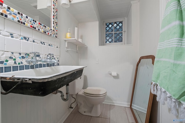 bathroom featuring hardwood / wood-style flooring and toilet