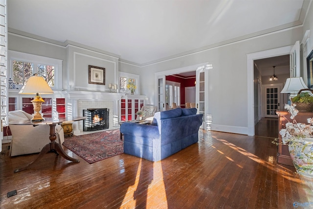 living room with hardwood / wood-style flooring and crown molding