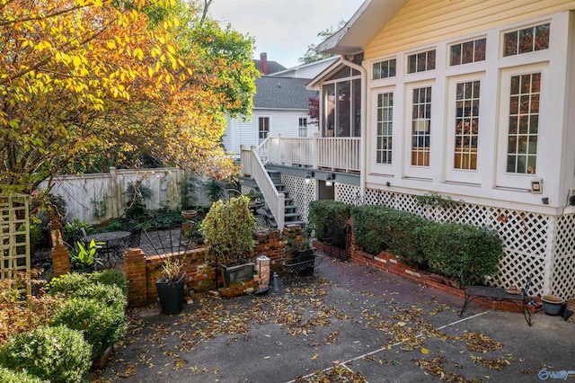 view of patio featuring a sunroom