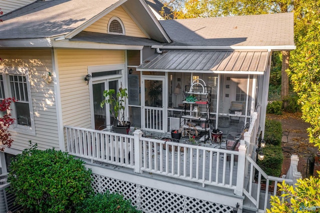 rear view of property featuring a sunroom