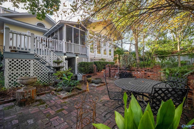 view of patio / terrace featuring a sunroom