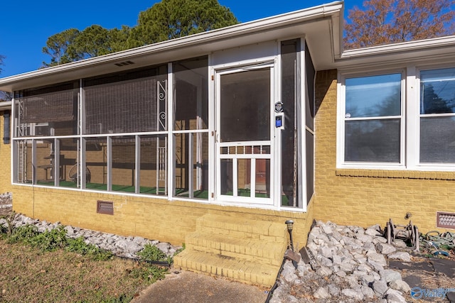 view of property exterior featuring a sunroom