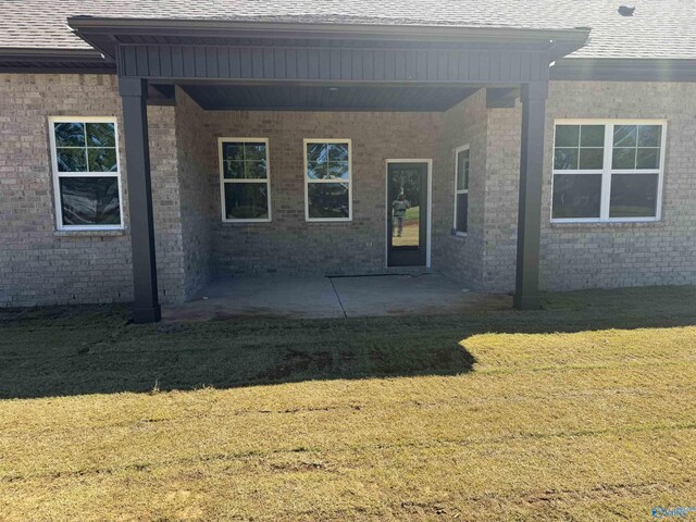 view of front of home featuring a patio area and a front lawn