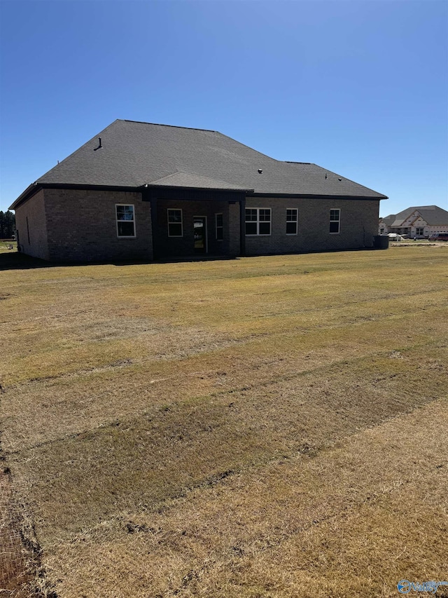 rear view of house with a yard