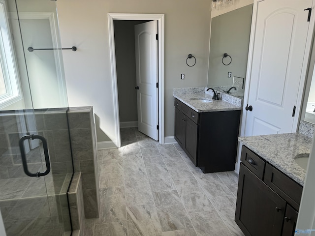 bathroom with vanity and a shower with door