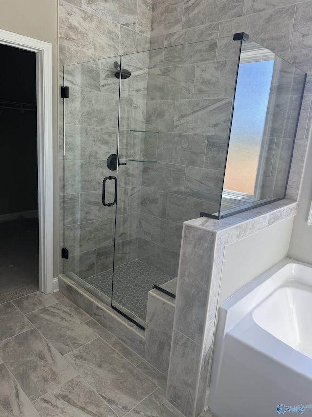 bathroom featuring shower with separate bathtub