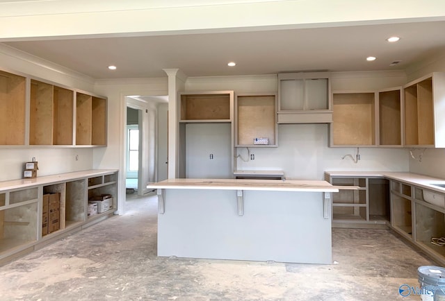 kitchen featuring crown molding and a breakfast bar area