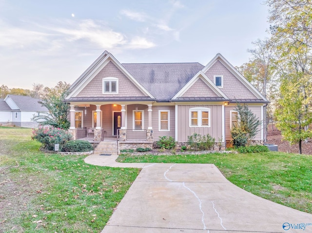 craftsman house with covered porch and a front lawn