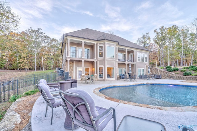 view of swimming pool featuring a patio and ceiling fan