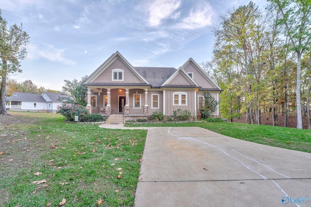 craftsman-style house with a porch and a front yard