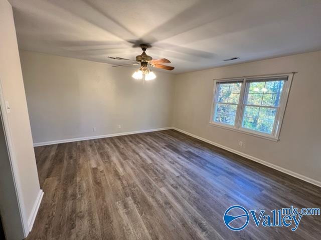 spare room featuring dark hardwood / wood-style floors and ceiling fan