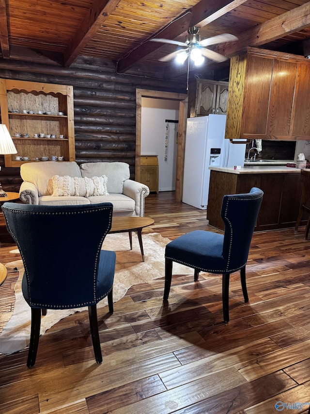 101 9th St W, Grant, AL 35747 - living area with wooden ceiling with exposed beams, ceiling fan, dark wood-type flooring, and rustic walls