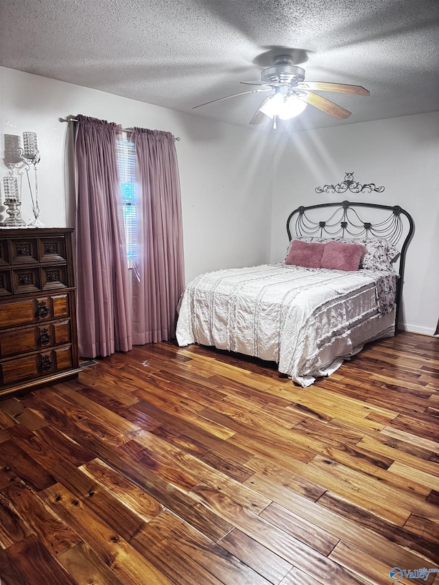 101 9th St W, Grant, AL 35747 - bedroom with hardwood / wood-style floors, a textured ceiling, and a ceiling fan