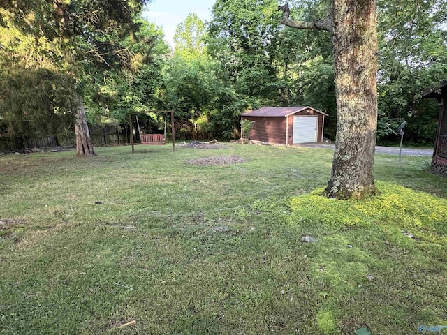 101 9th St W, Grant, AL 35747 - view of grassy yard featuring an outdoor structure and a detached garage