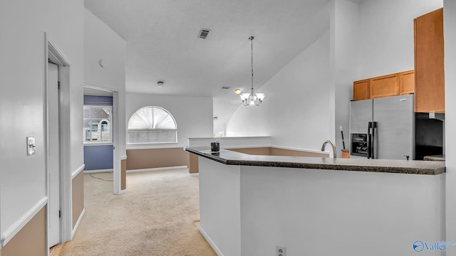 1155 Old Monrovia Rd NW Unit 2N, Huntsville, AL 35806 - kitchen featuring stainless steel fridge with ice dispenser, a peninsula, light colored carpet, decorative light fixtures, and brown cabinetry