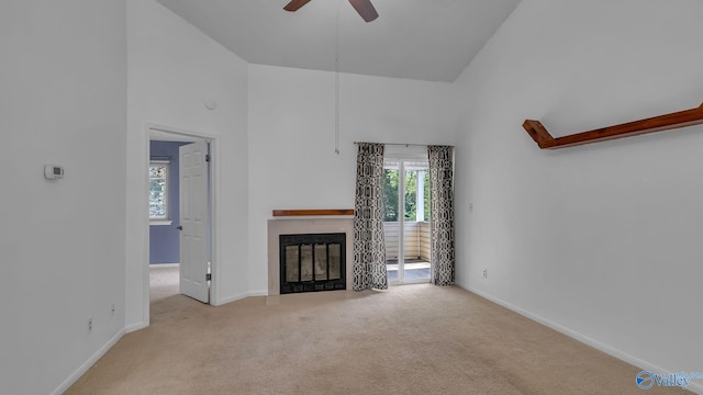 1155 Old Monrovia Rd NW Unit 2N, Huntsville, AL 35806 - unfurnished living room with a ceiling fan, carpet flooring, a glass covered fireplace, and high vaulted ceiling