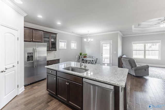 kitchen with dark wood-type flooring, stainless steel appliances, ornamental molding, and sink