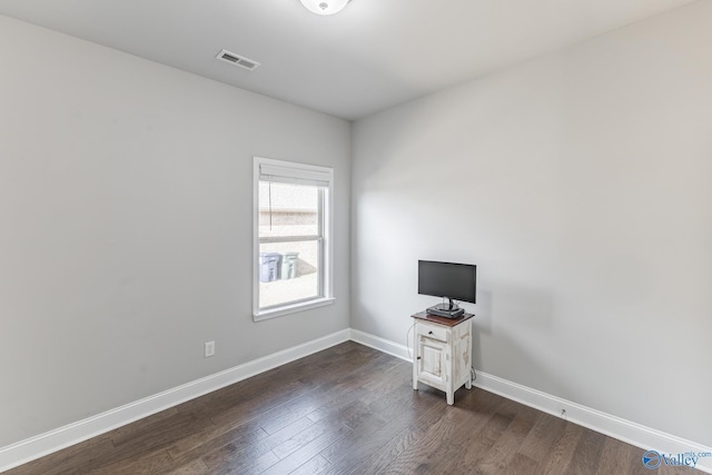 spare room with dark hardwood / wood-style flooring