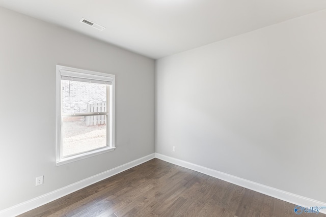 spare room with dark hardwood / wood-style flooring