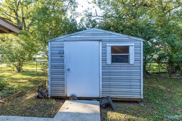 view of shed featuring fence
