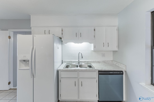 kitchen featuring a sink, white fridge with ice dispenser, dishwashing machine, white cabinetry, and light countertops