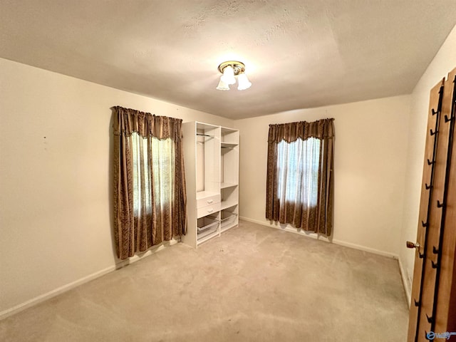 unfurnished bedroom with carpet floors and baseboards