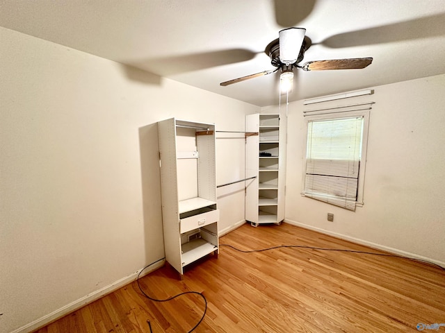 unfurnished bedroom featuring a ceiling fan, light wood-style flooring, and baseboards